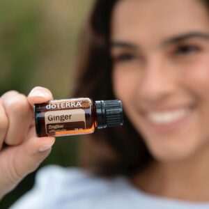 A Woman Holding a Doterra Ginger Essential Oil