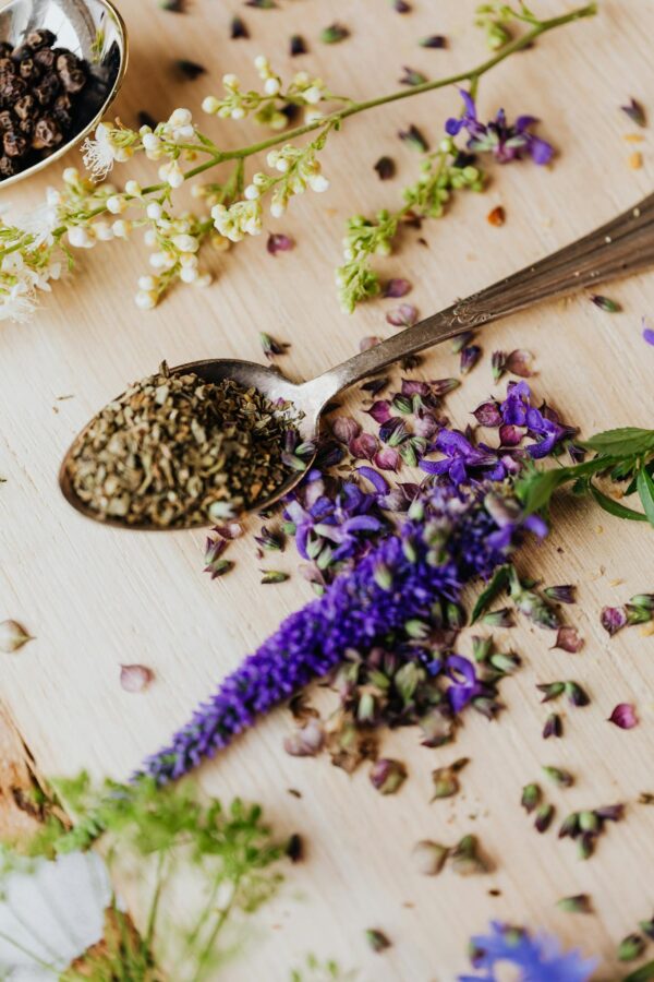 Edible Flowers Beside Spices and Herbs on Wooden Board